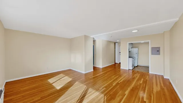 a view of a room with wooden floor