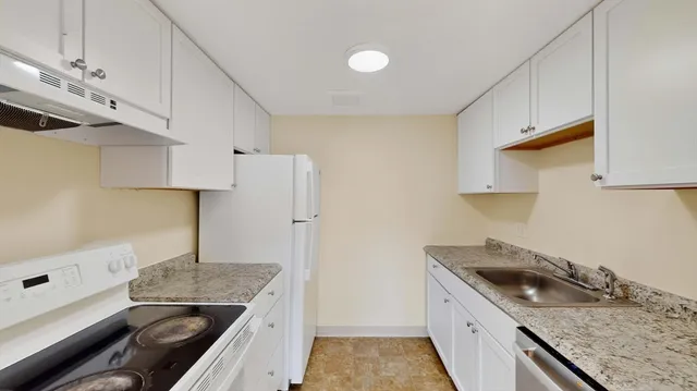 a kitchen with a sink stove and refrigerator