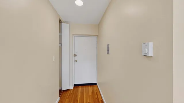 a view of a room with wooden floor