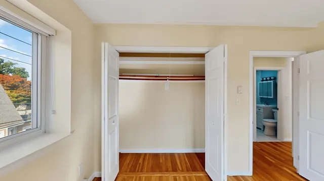 a view of walk in closet with wooden floor