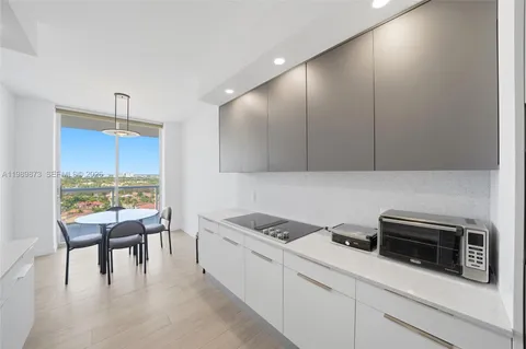 a kitchen with a table chairs stove and microwave