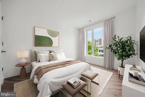 a bedroom with a bed and a window