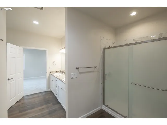 a bathroom with a sink vanity granite and a mirror