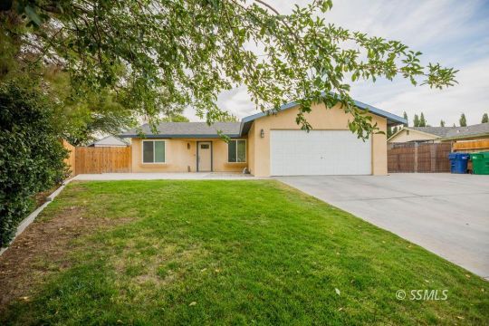 437 Emily Street Ridgecrest, CA 93555 - Photo 1 of 28 a front view of a house with a garden and tree