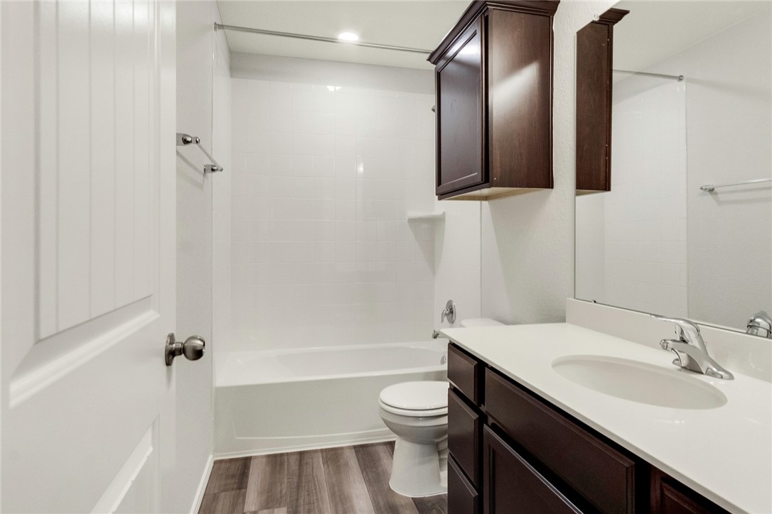 117 Nathaniel Drive Taylor, TX 76574 - Photo 20 of 26 a bathroom with a granite countertop sink toilet and shower
