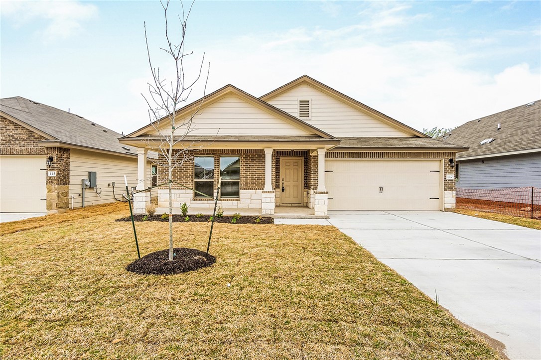 117 Nathaniel Drive Taylor, TX 76574 - Photo 2 of 26 a front view of a house with garden