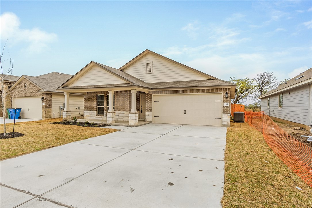 117 Nathaniel Drive Taylor, TX 76574 - Photo 3 of 26 a front view of a house with a yard and garage