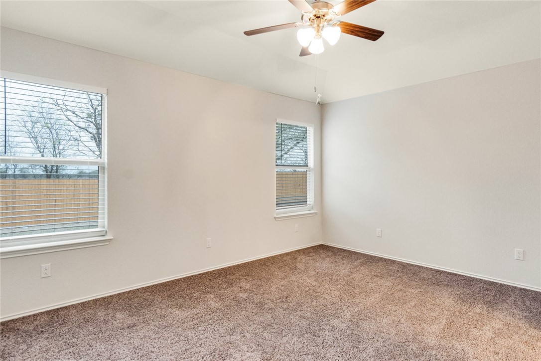 117 Nathaniel Drive Taylor, TX 76574 - Photo 9 of 26 an empty room with a window and a fan