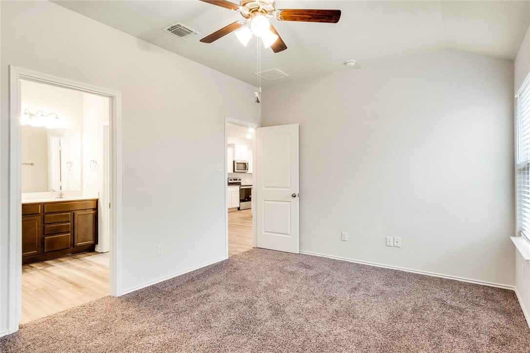 117 Nathaniel Drive Taylor, TX 76574 - Photo 10 of 26 an empty room with cabinet and windows