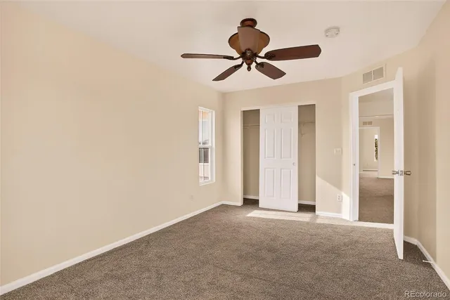 a view of room with ceiling fan and window