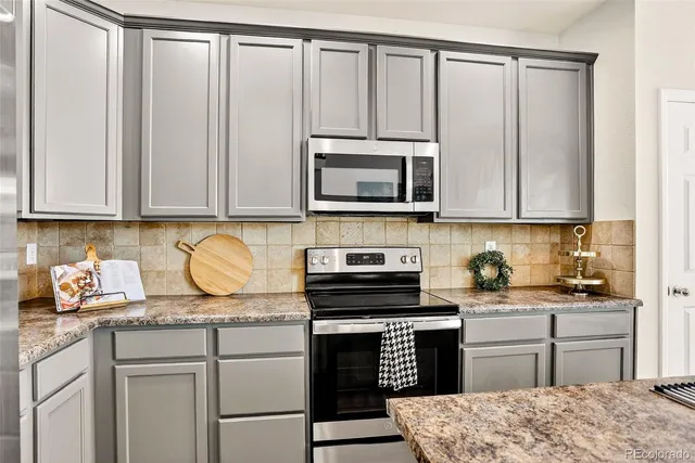 a kitchen with stainless steel appliances granite countertop a stove and a sink