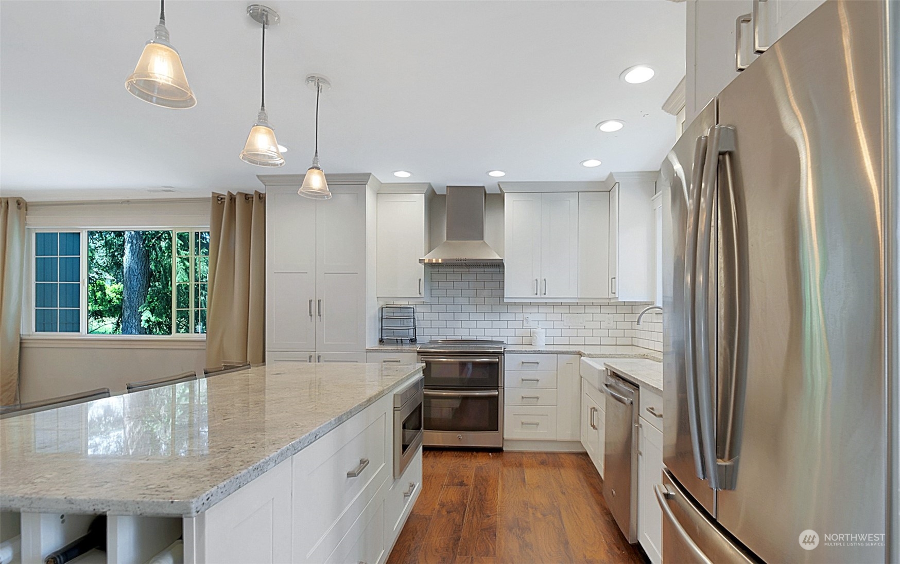 907 Harvest Road Bothell, WA 98012 - Photo 12 of 28 a kitchen with stainless steel appliances granite countertop a sink refrigerator and cabinets