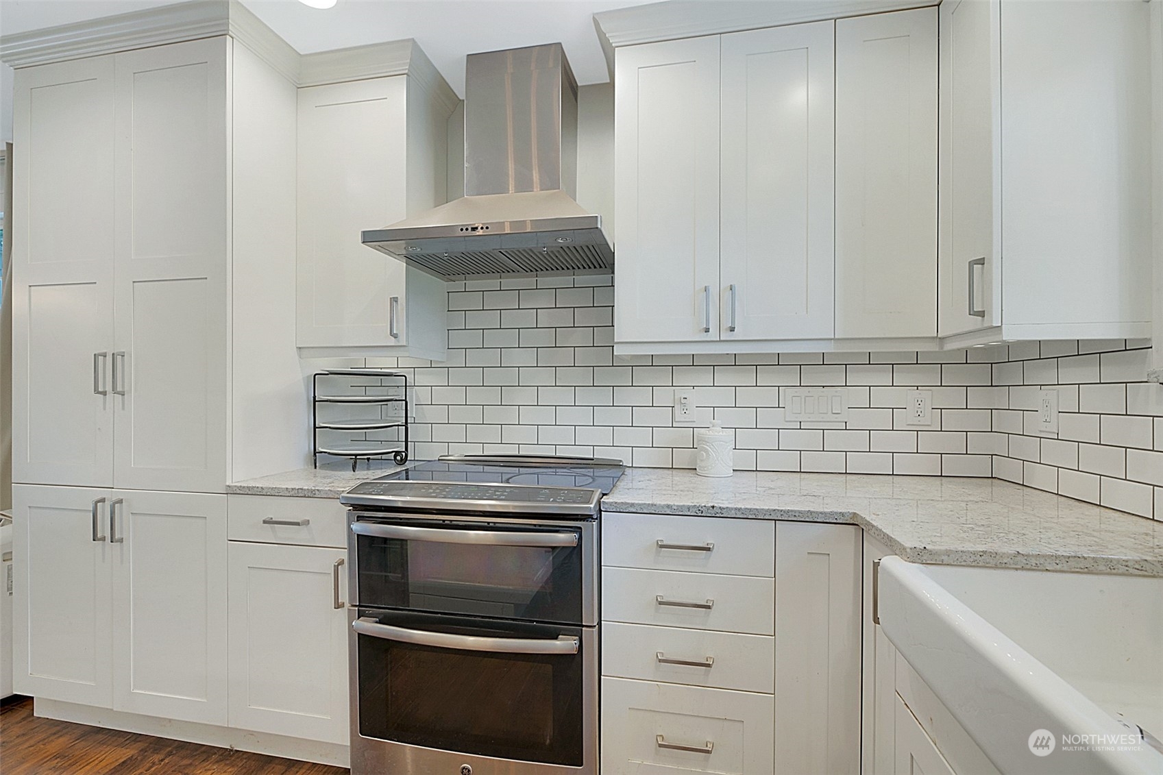 907 Harvest Road Bothell, WA 98012 - Photo 13 of 28 a kitchen with granite countertop white cabinets and stainless steel appliances