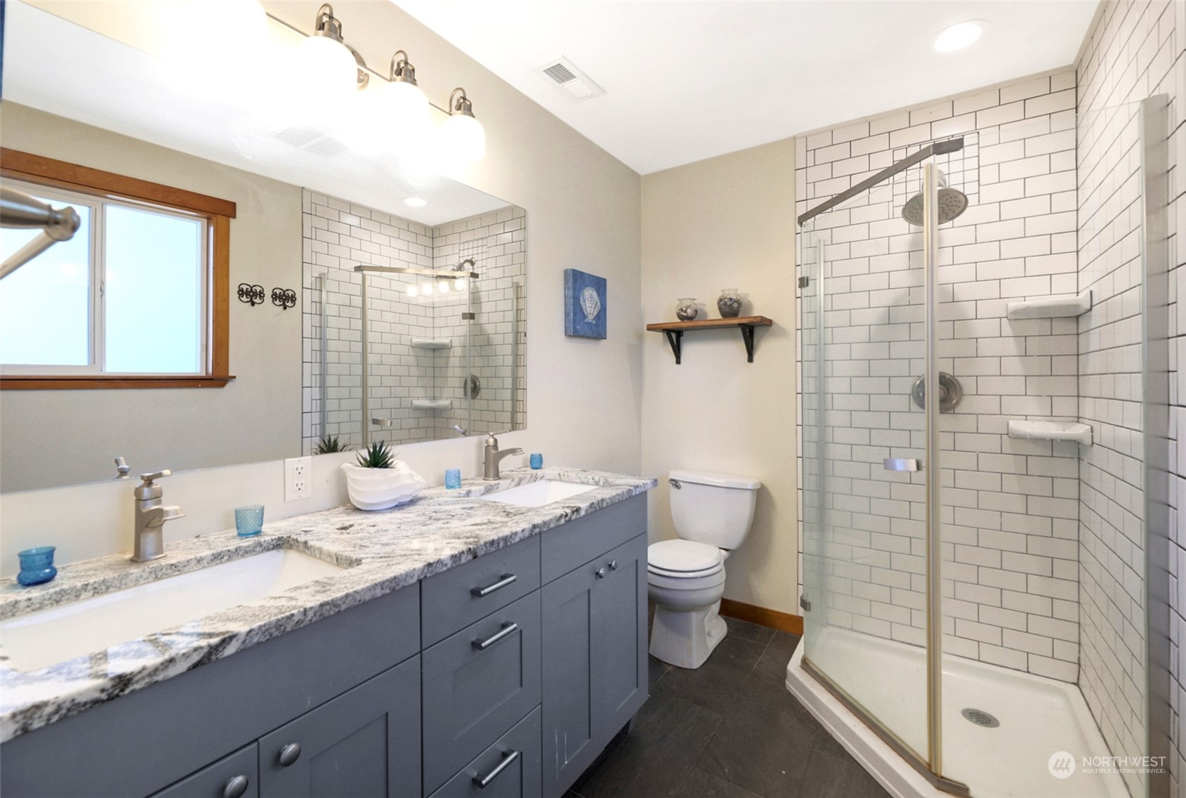 907 Harvest Road Bothell, WA 98012 - Photo 15 of 28 a bathroom with a granite countertop sink toilet and shower