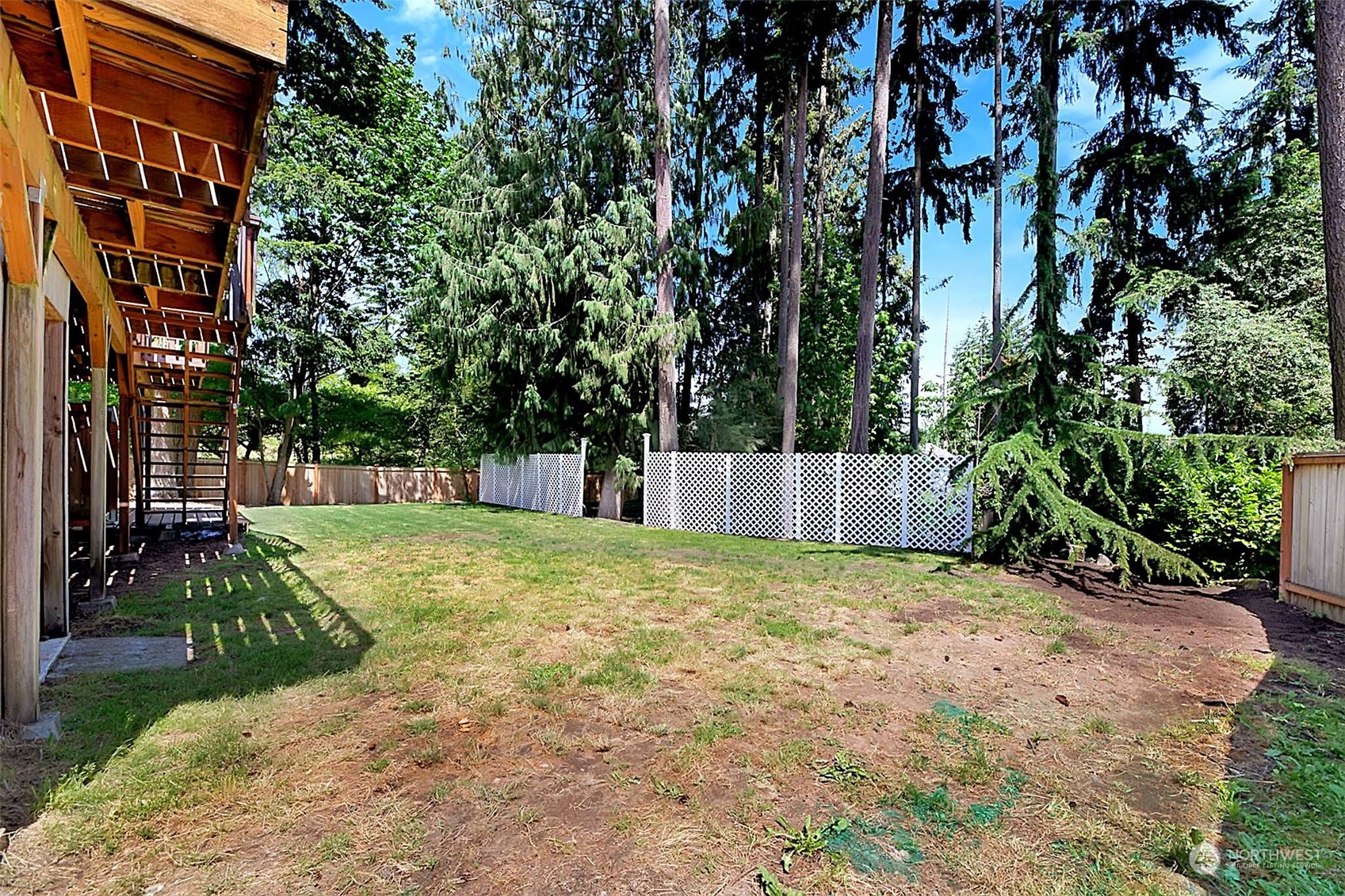 907 Harvest Road Bothell, WA 98012 - Photo 24 of 28 a view of a backyard with plants and large trees
