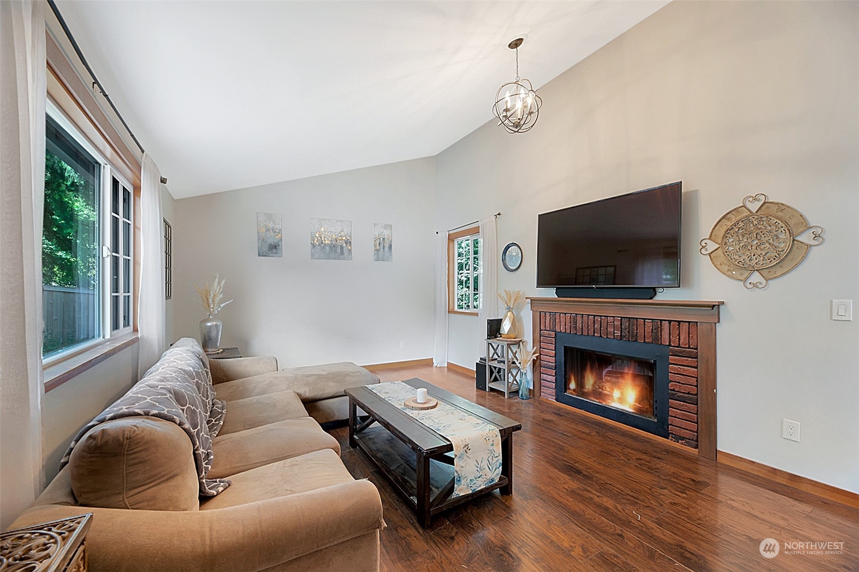 907 Harvest Road Bothell, WA 98012 - Photo 5 of 28 a living room with furniture a flat screen tv and a fireplace