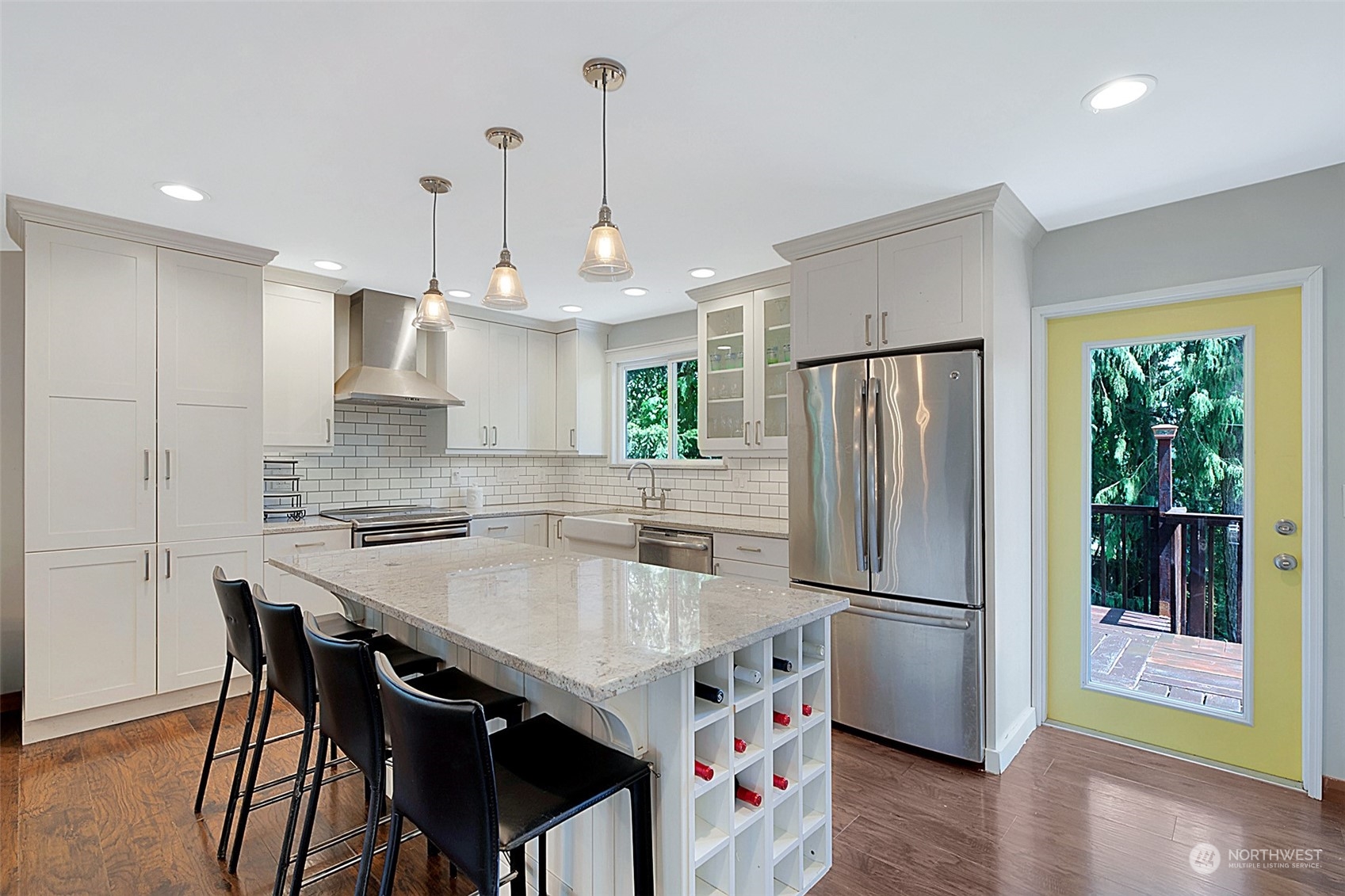 907 Harvest Road Bothell, WA 98012 - Photo 9 of 28 a kitchen with stainless steel appliances granite countertop a refrigerator a sink dishwasher a stove and a refrigerator with wooden floor