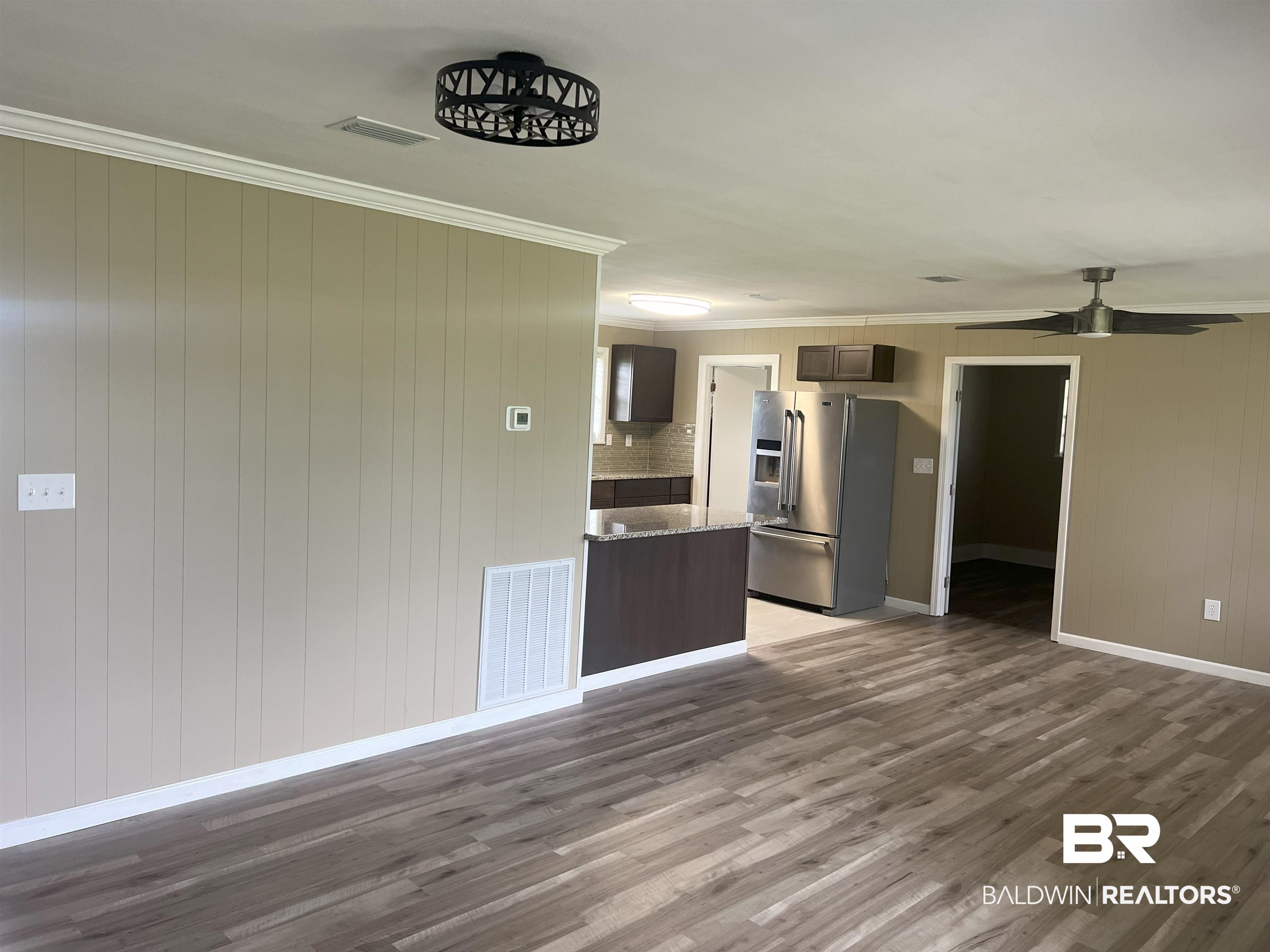 508 Freemanville Drive Atmore, AL 36502 - Photo 5 of 27 Kitchen featuring ceiling fan, dark hardwood / wood-style flooring, decorative backsplash, stainless steel fridge with ice dispenser, and stone countertops