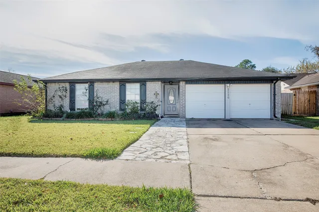 a front view of house with a garden