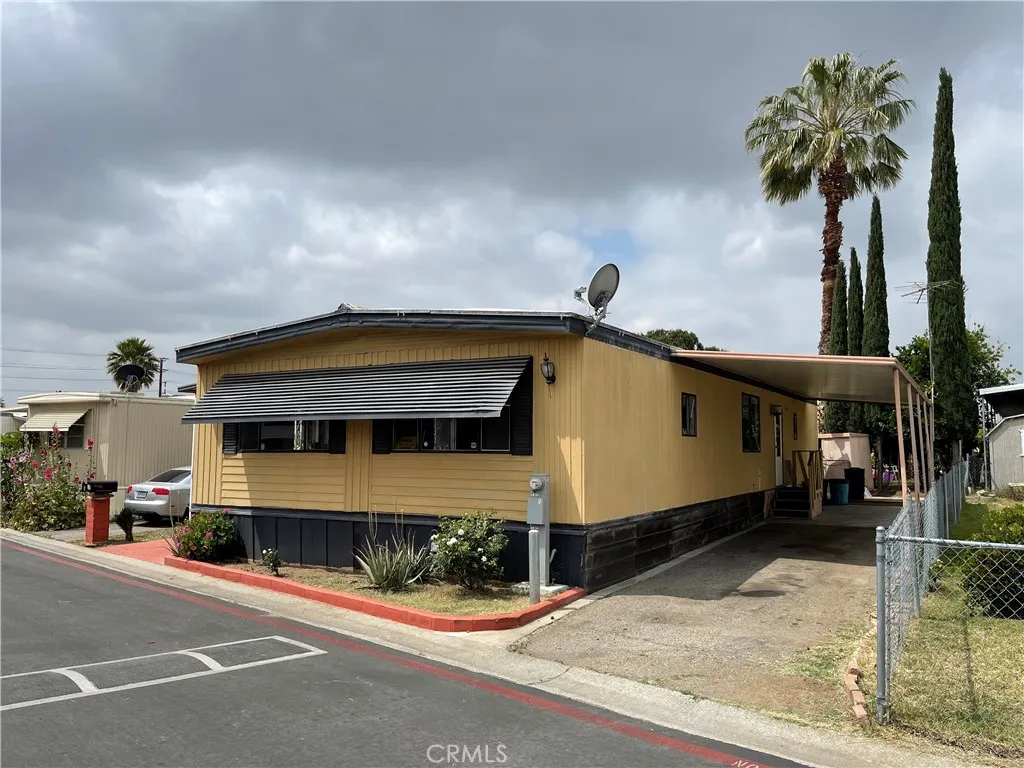 2930 West Rialto Avenue, Unit 12 Rialto, CA 92376 - Photo 1 of 1 a front view of a house with a yard