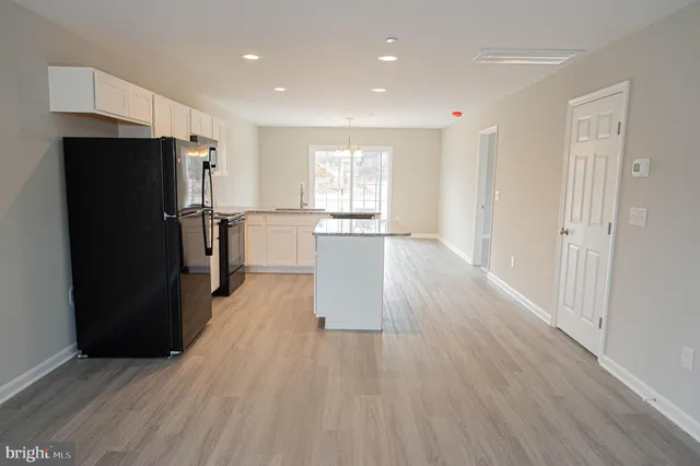 a kitchen with a refrigerator and a sink