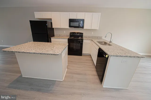 a en suite bathroom with a granite countertop sink and a vanity