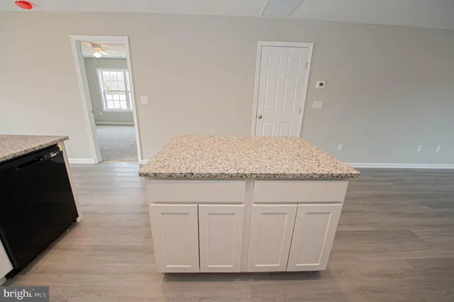 a kitchen with stainless steel appliances granite countertop a refrigerator stove and sink