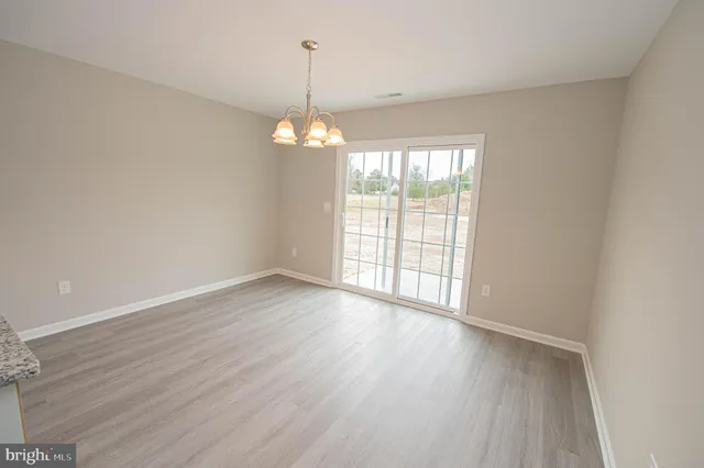 an empty room with a ceiling fan and a window