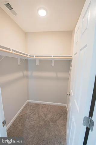 a spacious bathroom with a toilet sink and mirror
