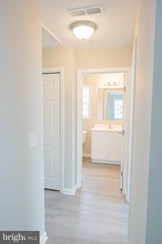 a bathroom with a sink toilet and mirror