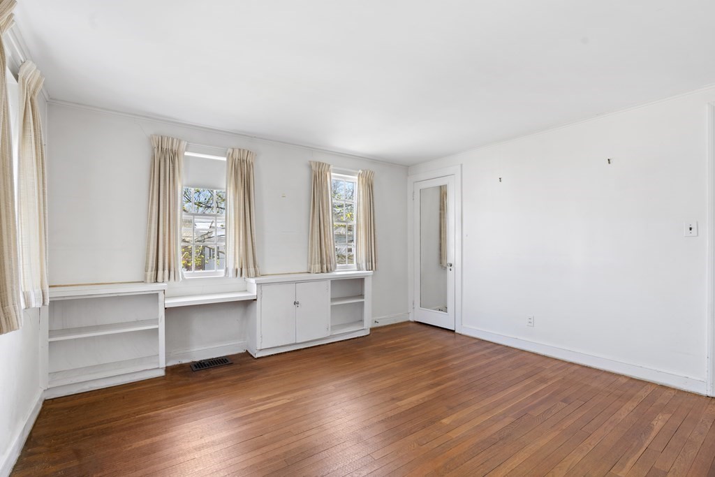 160 Reservoir Road Chestnut Hill, MA 02467 - Photo 15 of 42 an empty room with wooden floor and windows