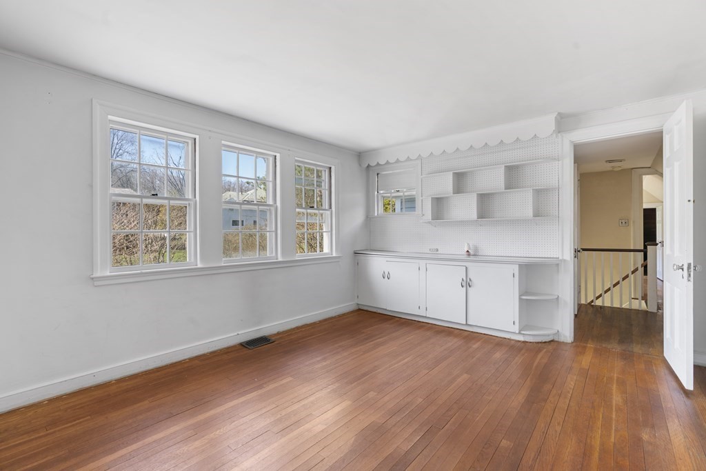 160 Reservoir Road Chestnut Hill, MA 02467 - Photo 17 of 42 an empty room with wooden floor and windows