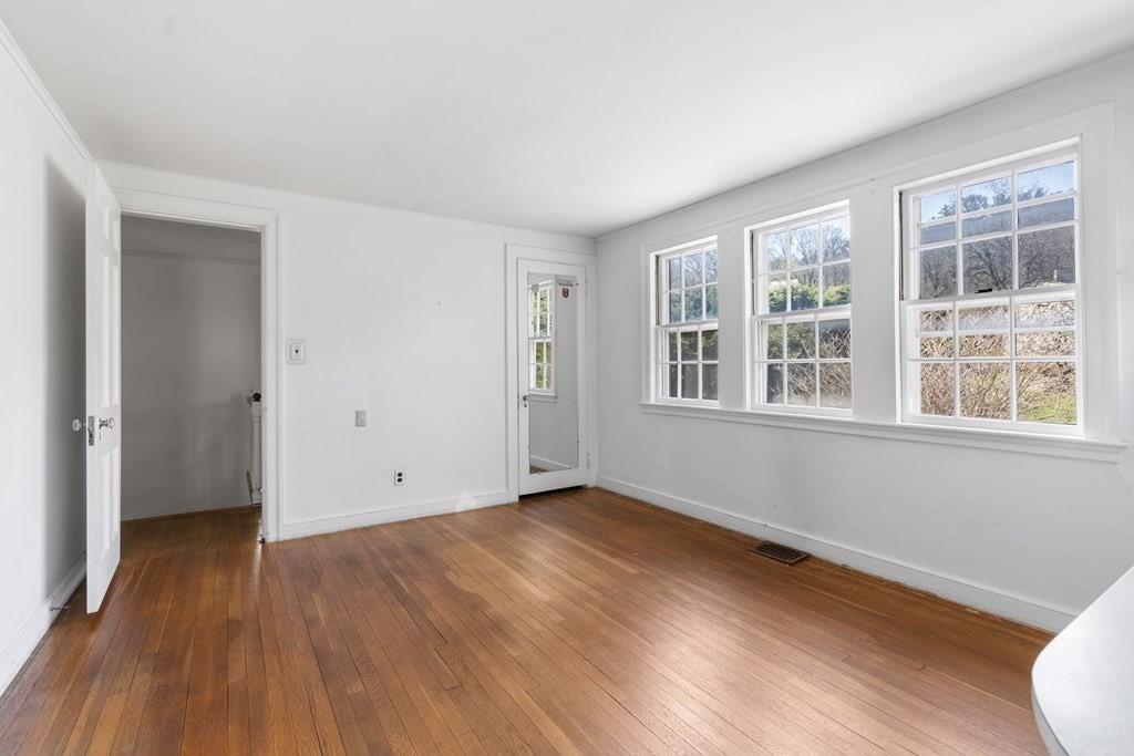 160 Reservoir Road Chestnut Hill, MA 02467 - Photo 18 of 42 a view of an empty room with wooden floor and a window