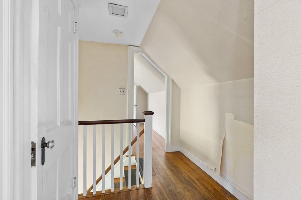 160 Reservoir Road Chestnut Hill, MA 02467 - Photo 19 of 42 a view of a hallway with wooden floor and staircase