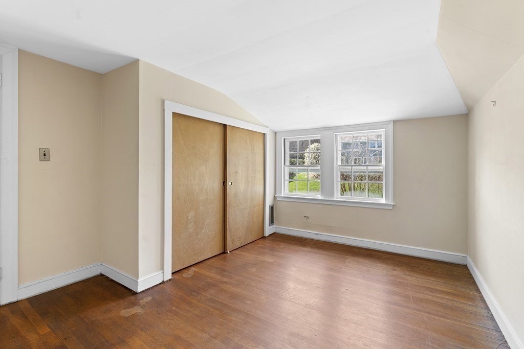 160 Reservoir Road Chestnut Hill, MA 02467 - Photo 20 of 42 an empty room with wooden floor and windows
