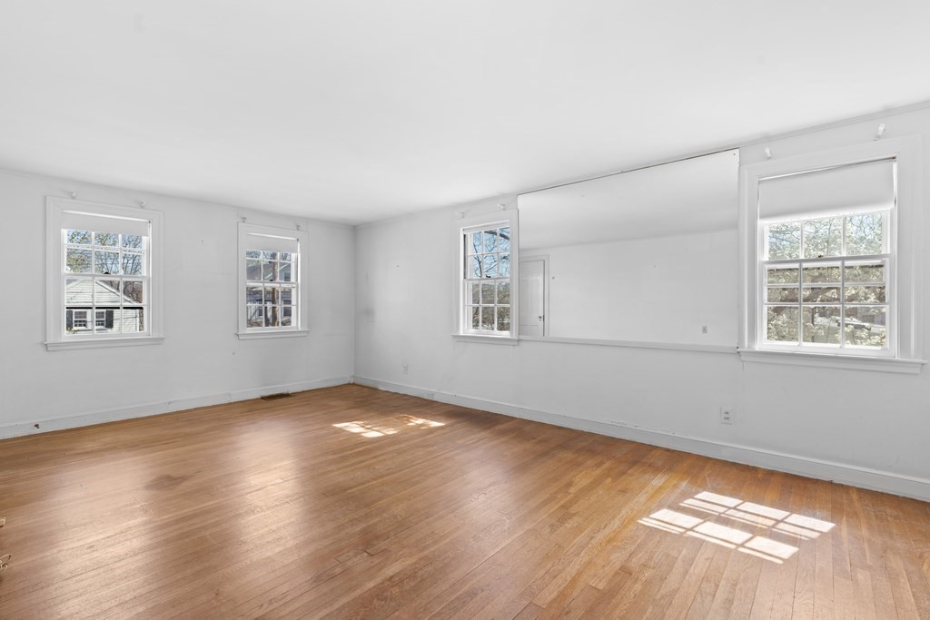 160 Reservoir Road Chestnut Hill, MA 02467 - Photo 21 of 42 a view of an empty room with wooden floor and a window