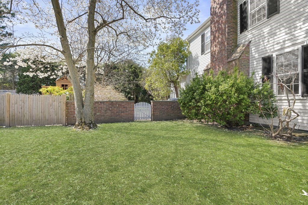 160 Reservoir Road Chestnut Hill, MA 02467 - Photo 30 of 42 a backyard of a house with plants and large tree
