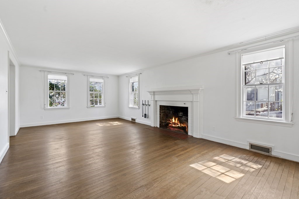 160 Reservoir Road Chestnut Hill, MA 02467 - Photo 3 of 42 a view of an empty room with a window and fireplace