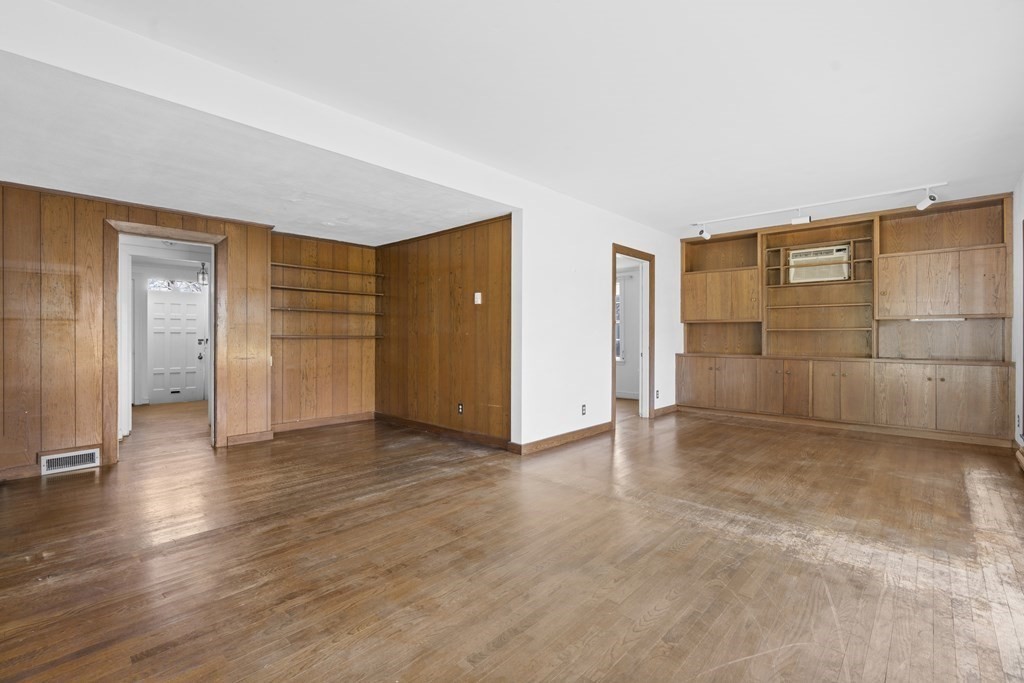 160 Reservoir Road Chestnut Hill, MA 02467 - Photo 6 of 42 an empty room with wooden floor and windows