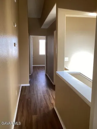 a view of hallway with wooden floor