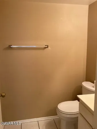 a white toilet sitting next to a shower