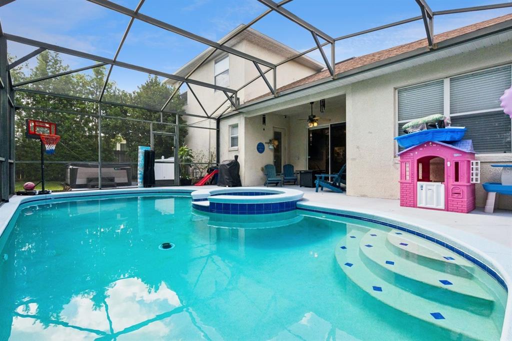 8484 Dover View Lane Orlando, FL 32829 - Photo 26 of 41 a view of a white building with swimming pool in front of it