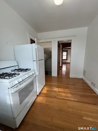 a kitchen with a stove and a refrigerator
