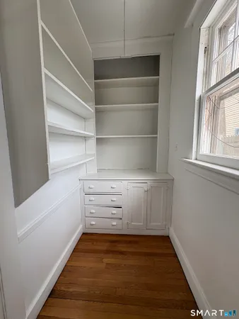 a view of walk in closet with empty racks
