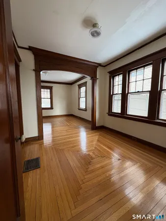 wooden floor in an empty room with a window