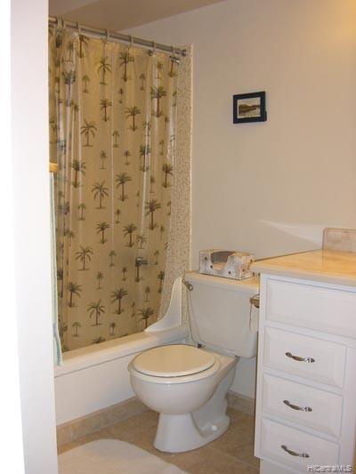 a white toilet sitting next to a shower curtain