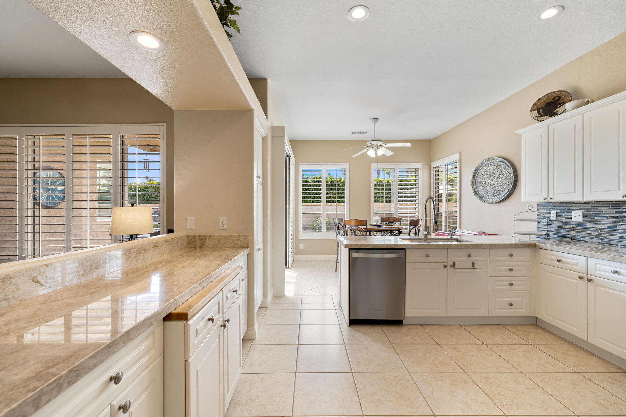 215 Strada Nova Palm Desert, CA 92260 - Photo 14 of 44 a large white kitchen with a large window