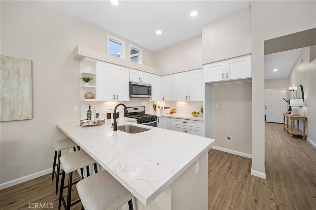 31577 Via Santa Ines Temecula, CA 92592 - Photo 18 of 49 a kitchen with white cabinets and refrigerator