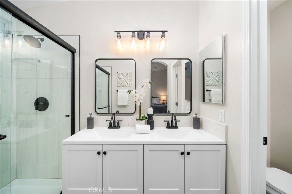 31577 Via Santa Ines Temecula, CA 92592 - Photo 28 of 49 a bathroom with double vanity sinks and a mirror