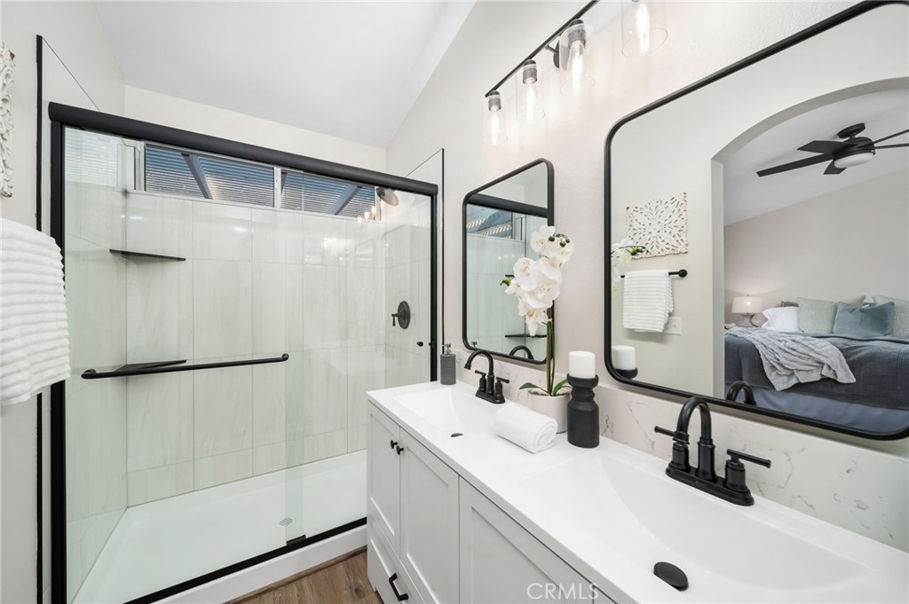 31577 Via Santa Ines Temecula, CA 92592 - Photo 29 of 49 a bathroom with a double vanity sink mirror and shower